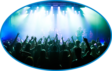 A concert in Charlotte with fans with their hands in the air enjoying the show.