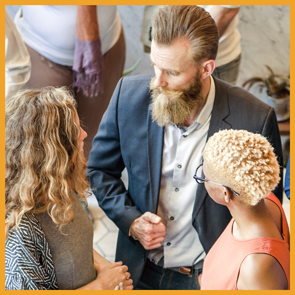Two business people shake hands and greet each other.