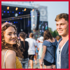 Friends enjoy live music at a music festival.